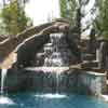 Swimming pool slide with waterfall